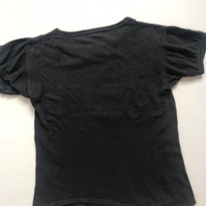 May include: A black short-sleeved t-shirt with a crew neck.