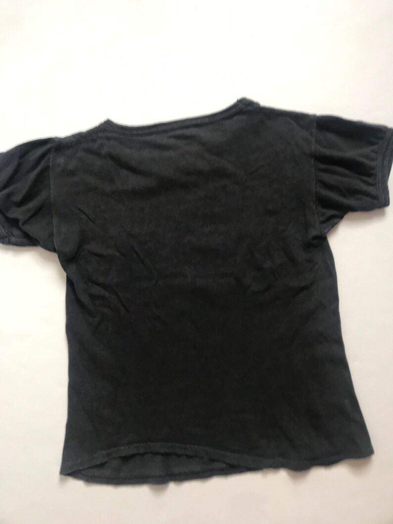 May include: A black short-sleeved t-shirt with a crew neck.