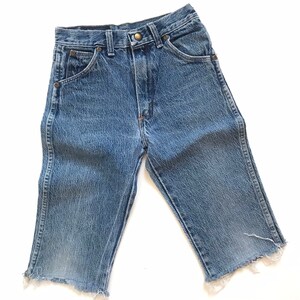 May include: A pair of light blue denim shorts with a frayed hem. The shorts have a classic five-pocket design and a button fly.