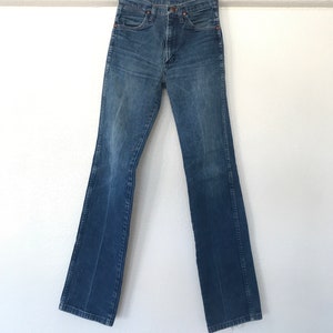May include: A pair of blue denim jeans with a straight leg and a slight flare at the bottom. The jeans have a high waist and a classic five-pocket design.