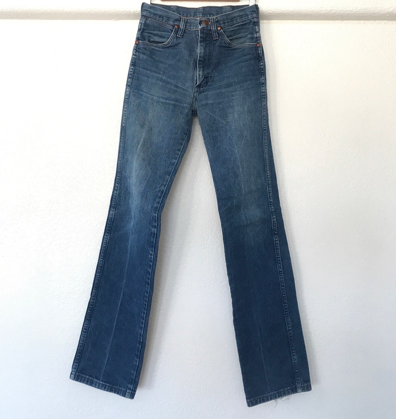 May include: A pair of blue denim jeans with a straight leg and a slight flare at the bottom. The jeans have a high waist and a classic five-pocket design.