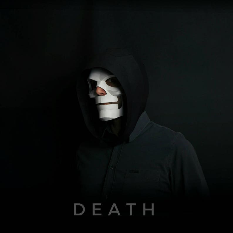 May include: A person wearing a black hooded sweatshirt and a white skull mask. The text "DEATH" is printed below the image.