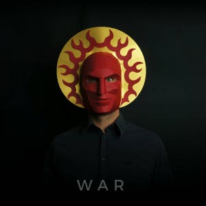 May include: A person wearing a red paper mask with a gold and red halo. The mask has a fierce expression and the halo has flames. The person is wearing a black shirt and the word "WAR" is printed below the image.