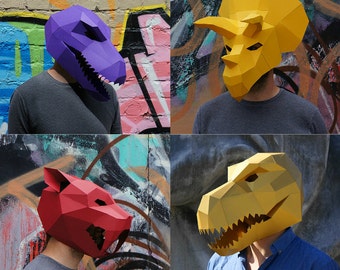 May include: Four different papercraft masks, each depicting a different animal. The masks are yellow, red, purple, and gold. The masks are worn by people in front of a graffiti wall.