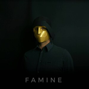 May include: A person wearing a black hooded garment and a gold mask with the word "FAMINE" printed below.