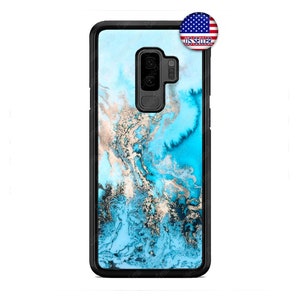 May include: A phone case with a black border and a blue marble design with gold and white accents. The case has a US Seller sticker in the upper right corner.