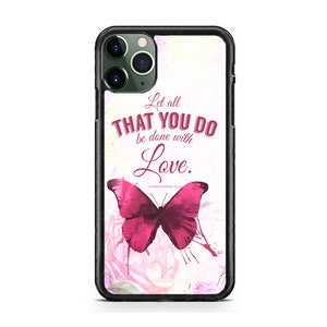 May include: A pink and white iPhone case with a butterfly design and the quote "Let all that you do be done with love."  1 Corinthians 16:14.