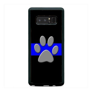 May include: Black phone case with a blue and gray paw print and a thin blue line across the middle.