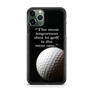 May include: Black iPhone case with a white golf ball and the quote "The most important shot in golf is the next one."
