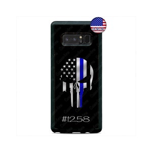 May include: Black phone case featuring a skull design with a blue line and American flag elements. The case has the number #1258 at the bottom. A US Seller sticker is in the upper right corner.
