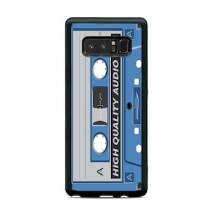 May include: A black phone case with a blue and white cassette tape design. The cassette tape has the text "HIGH QUALITY AUDIO" printed on it.