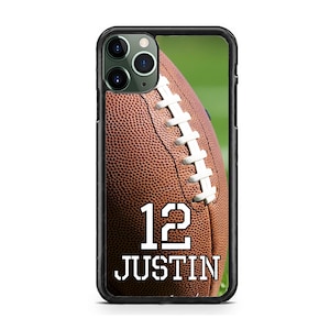 May include: A black phone case with a brown and white football design. The football has the number "12" and the name "JUSTIN" printed on it.