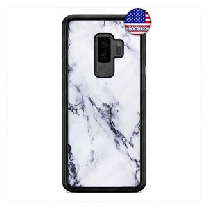 May include: A black phone case with a white marble design. The case has a raised black border around the edges.