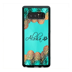 May include: A turquoise blue phone case with a black border and a design of pineapples and the word "Aloha" with a small black hibiscus flower.