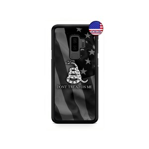 May include: Black phone case with a gray and black American flag design. The flag has a snake with the words "Don't Tread On Me" underneath.