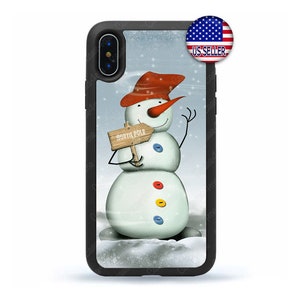 May include: A black phone case with a snowman illustration. The snowman is wearing a red hat and holding a sign that says "North Pole".