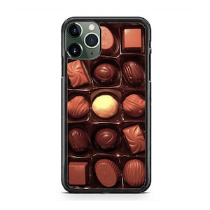 May include: A black iPhone case with a close-up image of a variety of chocolate candies in a box. The candies are arranged in rows and include milk chocolate, dark chocolate, and white chocolate.