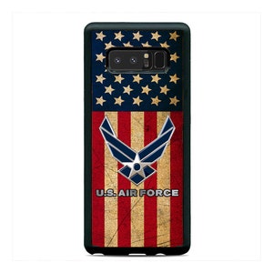 May include: A black phone case with a distressed American flag design and the U.S. Air Force logo. The flag is red, white, and blue with a faded look.