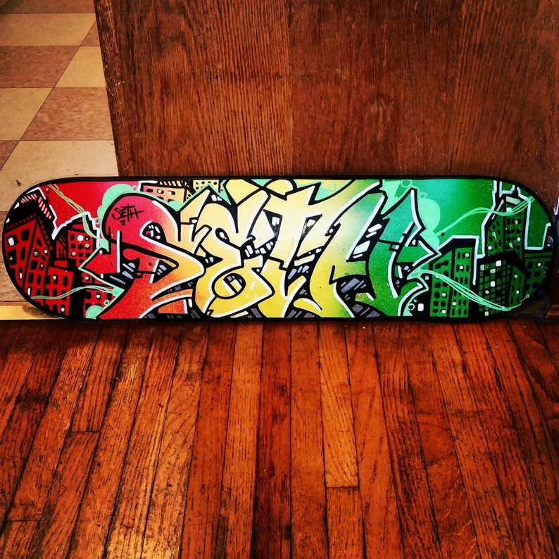 "Seth" custom painted graffiti skateboard painted by Orikal Uno of Graff Roots Media