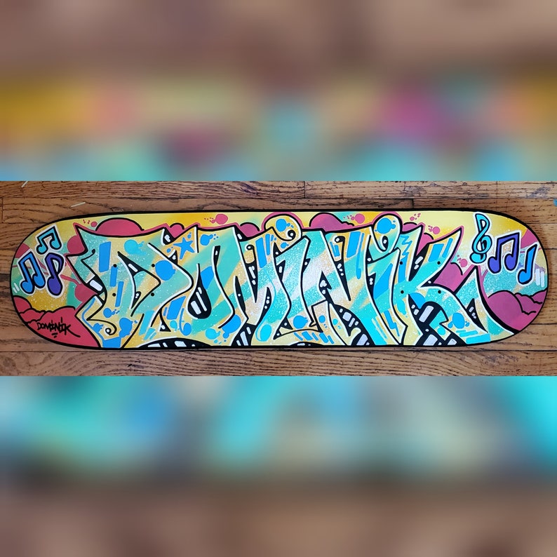 "Dominik" custom painted graffiti skateboard painted by Orikal Uno of Graff Roots Media