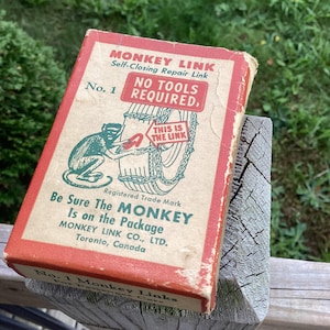 May include: A vintage box of Monkey Link self-closing repair links for tires. The box is red and white with a green monkey illustration. The text on the box reads "Monkey Link, Self-Closing Repair Link, No. 1, No Tools Required, Be Sure The Monkey Is on the Package, Monkey Link Co., Ltd., Toronto, Canada".