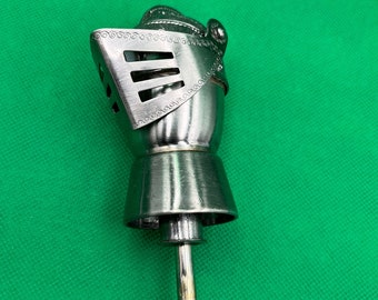 May include: Silver bottle stopper shaped like a knight's helmet with a decorative design.