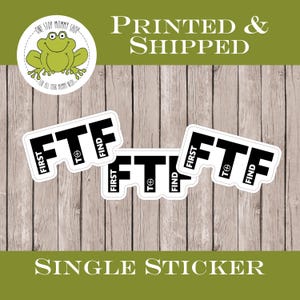 May include: White stickers with the text "FTF" in bold black letters, with "FIRST" and "FIND" on the sides. A green frog logo and the words "ONE STOP MOMMY SHOP" are also visible. The words "PRINTED & SHIPPED" and "SINGLE STICKER" are also present.