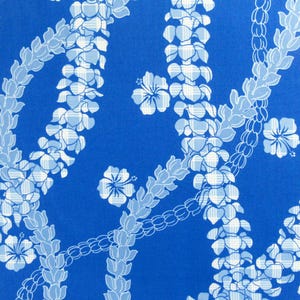May include: A vibrant blue fabric featuring a repeating pattern of white and light blue floral garlands and individual hibiscus flowers. The design has a tropical, Hawaiian aesthetic, suitable for apparel or home decor.