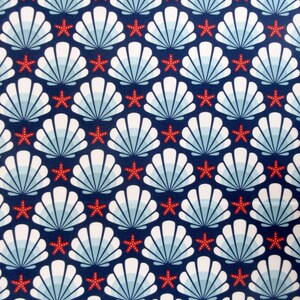 May include: A seamless pattern featuring white seashells with blue and white stripes on a navy blue background. Red five-pointed stars are scattered throughout the pattern.