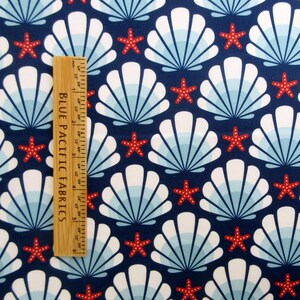 May include: Navy blue fabric with a repeating pattern of white seashells and red starfish. The fabric has a subtle blue and white ombre effect in the seashells.
