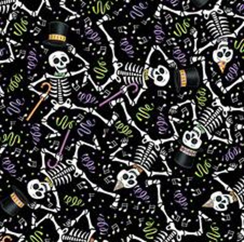 May include: A black fabric featuring a repeating pattern of white skeletons in various poses. Some skeletons wear top hats and hold canes. Green, purple, and yellow confetti and musical notes are scattered across the design.