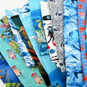May include: A collection of 10 different fabric panels featuring a variety of ocean-themed designs. The panels are made of cotton and are perfect for quilting, crafts, and home decor. The designs include sea creatures, seashells, and nautical patterns.
