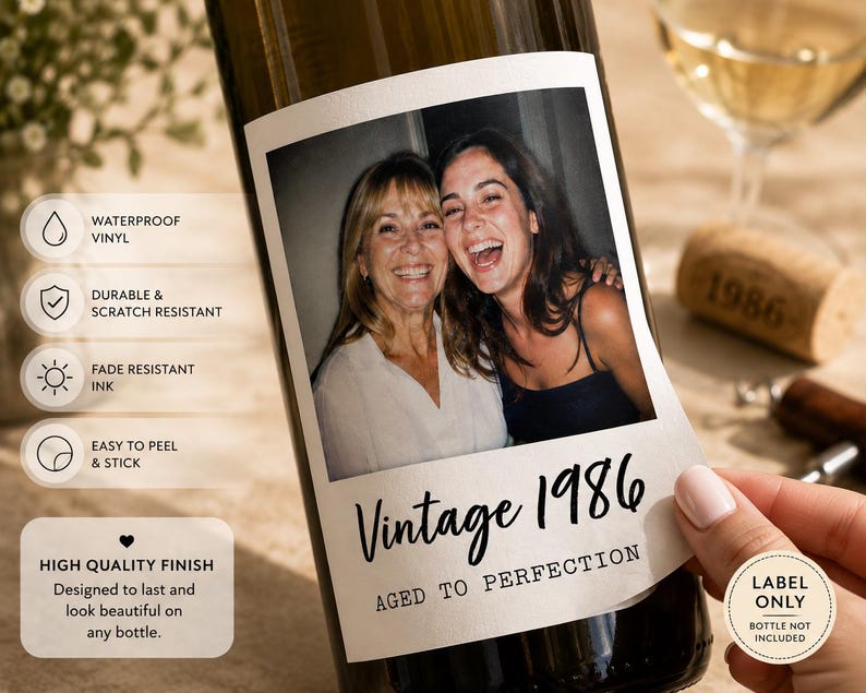 May include: A rectangular adhesive wine bottle label featuring a color photograph of two smiling people. The label includes the text Vintage 1986 and AGED TO PERFECTION in black font. Additional text icons indicate waterproof vinyl, durable, scratch resistant, and fade resistant ink.