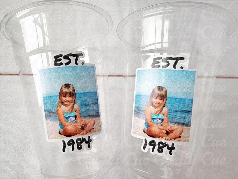 Personalized plastic cup with custom face and vintage year design. Birthday party decoration and unique celebration favor.