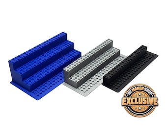 May include: Three tiered display stands with a stud-covered surface compatible with building blocks. The stands are blue, light gray, and black. A circular logo in the bottom right corner features the text RC MAKER SHOP EXCLUSIVE.