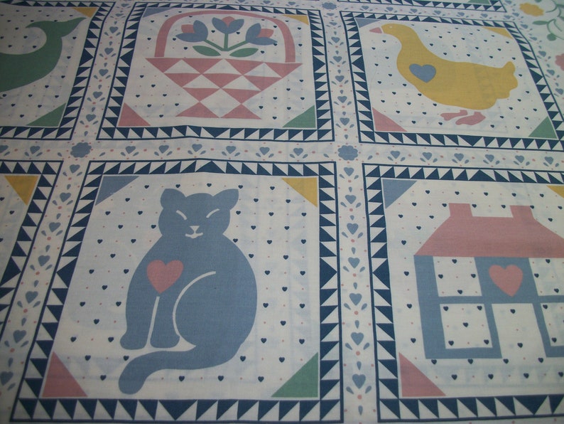 May include: A patterned fabric featuring repeating squares with various illustrations. Each square contains a different design, including a cat, a house, a goose, and a basket of flowers. The fabric has a white background with blue, pink, yellow, and green accents.