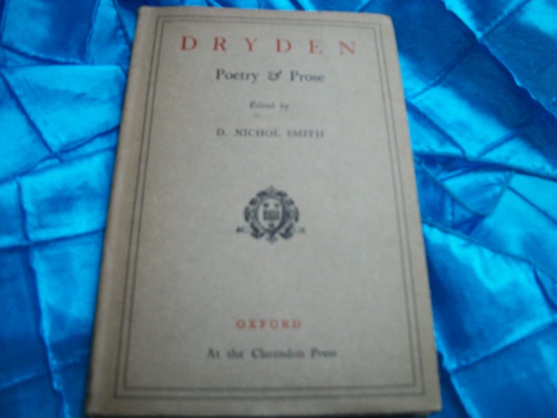 May include: A vintage book titled "Dryden Poetry & Prose" with a beige cover and black text. The book is edited by D. Nichol Smith and published by Oxford at the Clarendon Press. The cover features a decorative emblem.