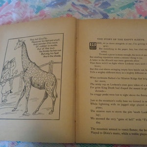 May include: Open book with illustrations and text. One page features a giraffe cartoon with a poem. The opposite page contains a poem titled "THE STORY OF THE EMPTY SLEEVE". The book's pages are aged with a red spine.