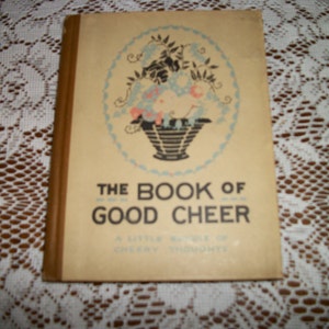 May include: A vintage book titled "The Book of Good Cheer: A Little Bundle of Cheery Thoughts" with a floral illustration on the cover.