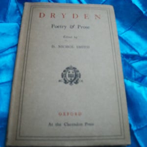 May include: A vintage book titled "Dryden Poetry & Prose" with a beige cover and black text. The book is edited by D. Nichol Smith and published by Oxford at the Clarendon Press. The cover features a decorative emblem.