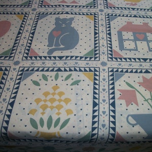May include: White fabric with a repeating pattern of squares. Each square features a different design, including a cat with a heart, a house, a heart with flowers, and a floral arrangement. The squares are outlined in blue.