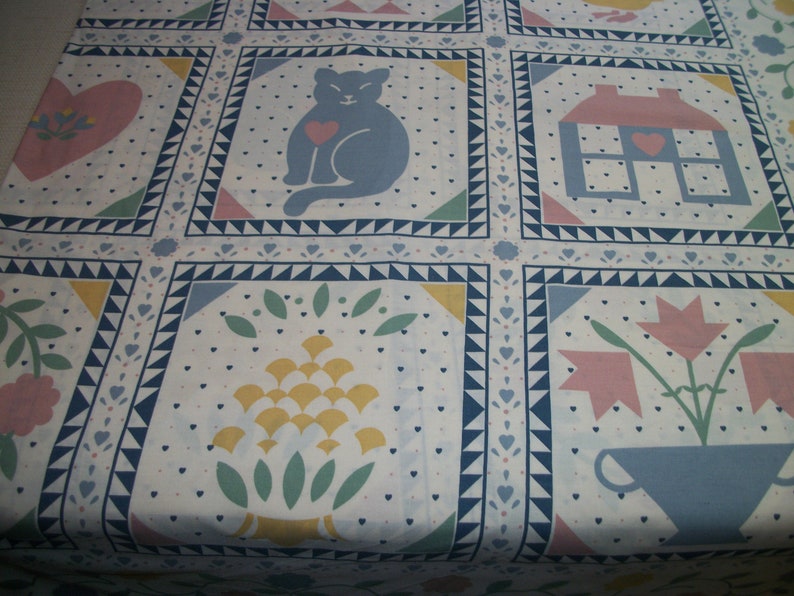 May include: White fabric with a repeating pattern of squares. Each square features a different design, including a cat with a heart, a house, a heart with flowers, and a floral arrangement. The squares are outlined in blue.