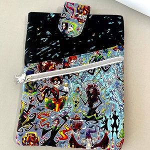 May include: A black and blue zippered pouch with a Harry Potter themed print. The print features various characters from the Harry Potter series, including Harry Potter, Hermione Granger, Ron Weasley, and Draco Malfoy. The pouch has a black fabric flap with a zipper closure.