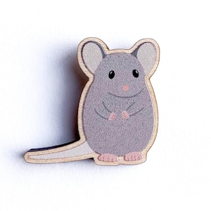 May include: A grey wooden mouse with pink ears and a pink nose. The mouse is standing on a white background.