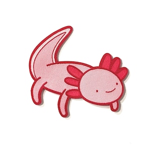May include: A pink and red axolotl cartoon patch with a smiling face. The axolotl is a type of salamander that is native to Mexico.
