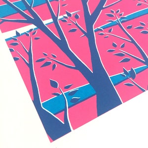 May include: A print featuring a stylized illustration of trees with blue branches and leaves against a pink and blue striped background. The print is numbered 1/34 in the lower right corner.