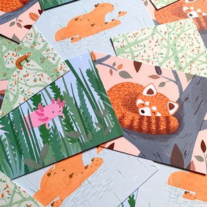 May include: A set of illustrated cards featuring various animals in a nature setting. The cards feature a red panda sleeping in a tree, a red panda with cubs, a capybara with cubs, an axolotl, and a red panda with cubs swimming in a pond.
