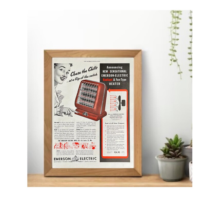 May include: A framed vintage advertisement for an Emerson-Electric Radiant & Fan-Type Heater. The ad features a red heater with a woman pointing at it. Text includes "Chase the Chills...at a flip of the switch" and "Announcing NEW SENSATIONAL".