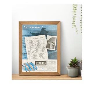 May include: A vintage advertisement for Hamilton watches featuring a handwritten letter from a soldier in the Pacific. The letter reads "I'm coming home!" and is accompanied by a photo of the soldier in uniform. The ad also features a photo of a ship and three Hamilton watches.