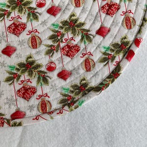 Delicate Red Christmas Ornaments Hanging From Holly Boughs on a White Background, Quilted Round Placemats, Sold in Sets of 2